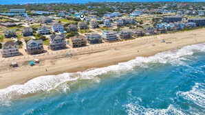A coastal residential area with beachfront properties, a sandy beach, and ocean waves. - Semi-oceanfront house with private pool, hot tub, & ocean views (Avon)