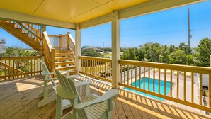 A wooden deck with a pool, chairs, and a staircase. - Semi-oceanfront house with private pool, hot tub, & ocean views (Avon)