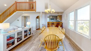 A spacious dining area with a high ceiling and a staircase leading to an upper level. - Amazing dog-friendly home with private pool, game room, AC, & W/D - near beach (Salvo)