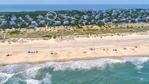 An aerial view of a beach with houses in the background and a sandy beach in the foreground. - Amazing dog-friendly home with private pool, game room, AC, & W/D - near beach (Salvo)