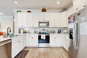 Fridge, microwave, oven, stovetop - Splendid home near the beach with private outdoor pool, patio, grill, W/D, & AC (Oak Island)