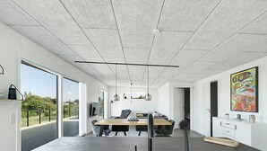 A modern office space with a large desk, chairs, and a view through glass doors. - 5 Star Holiday Home in Allinge (Allinge)