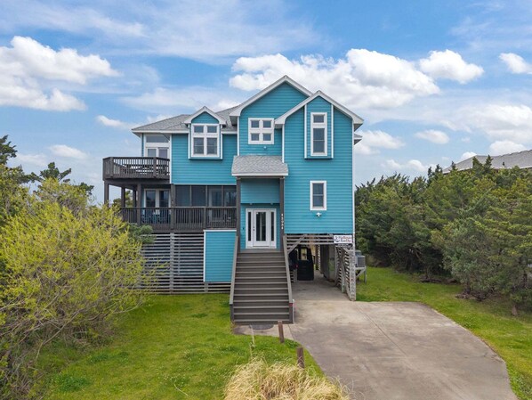A two-story house with a balcony, a front door, and a staircase leading to the entrance. - As Good As It Gets: Dog-Friendly, Private Hot Tub, Shared Pool & Views (Avon)