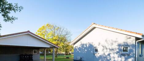 A building with a covered area and a separate house-like structure.