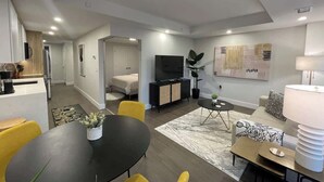 A modern apartment with a dining area, living room, and kitchen. - Downtown, bright & cozy 1 BR with 6 appliances (Halifax)