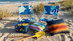 Beach chairs, a beach bag, a towel, a beach pillow, and a shovel on the sand. - Coastal Charm! 2-bedroom house in lovely Gulfport. (Gulfport)