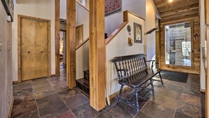 A wooden staircase with a bench, a patterned rug, and a large window. - Serene Ski Retreat w/Elkhorn in SV amenity pass! (Sun Valley)