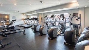 A gym with treadmills, elliptical machines, and a rowing machine.