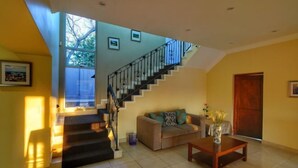 A spacious living area with a staircase, a sofa, and a coffee table.