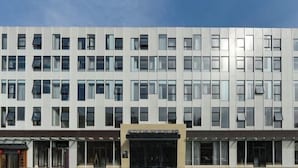 A modern hotel with a symmetrical facade, multiple windows, and a central entrance. - Atour Hotel（Beijing Chaoyang Park Red Scarf Bridge） (Beijing)
