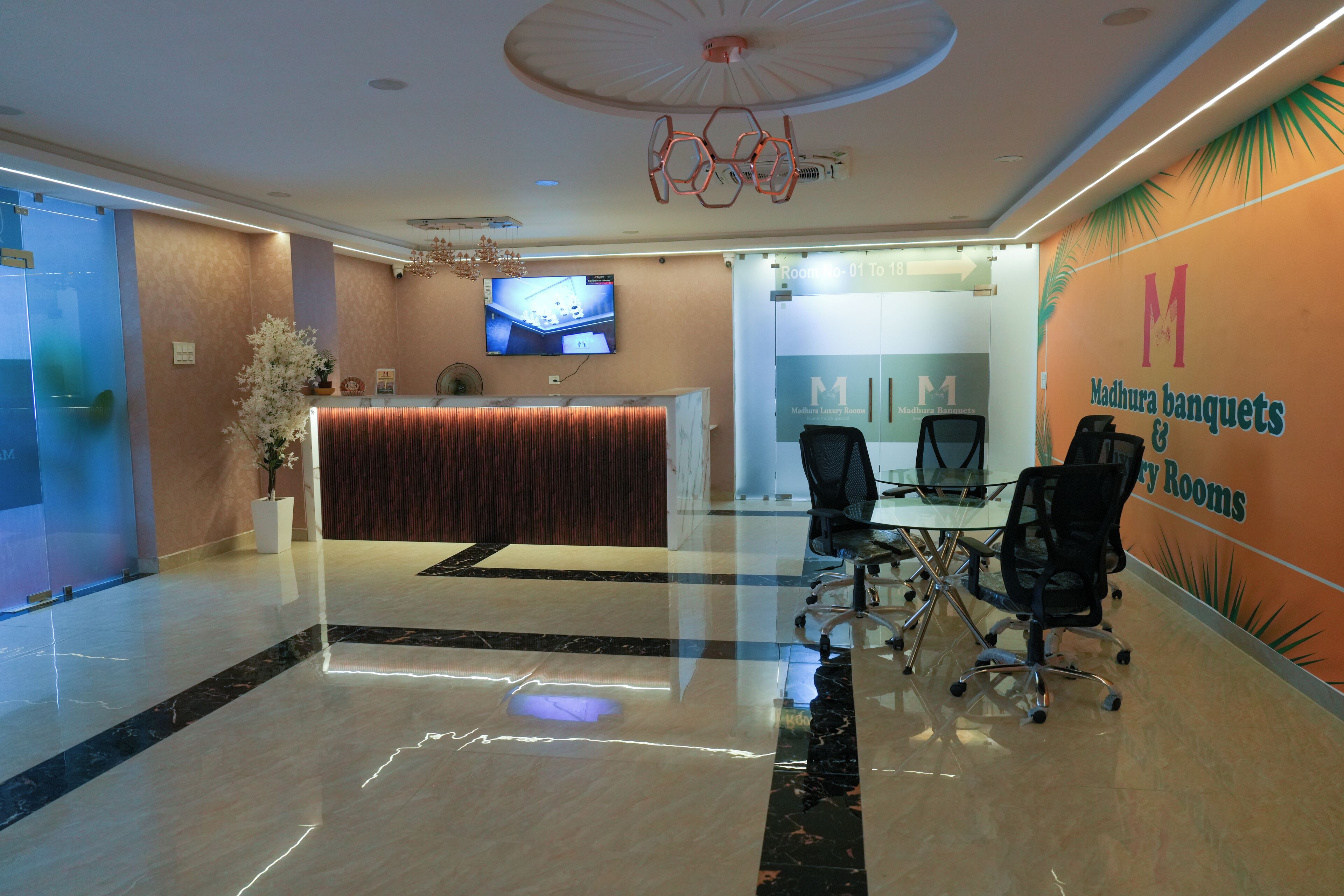 A reception area with a reception desk, a television, and a seating area with chairs.