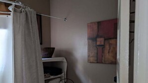 A small bathroom with a toilet, a shelf with towels, and a shower curtain. - Gate House (2 Doubles + 1 Single - 2nd Floor) (Lancaster)