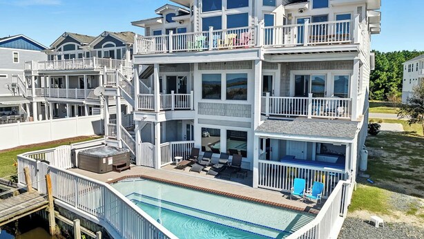 A multi-story beachfront property with a swimming pool, balconies, and outdoor seating areas. - Bella Vista II | 3,144 ft to the beach | Private Pool and Hot Tub (Corolla)