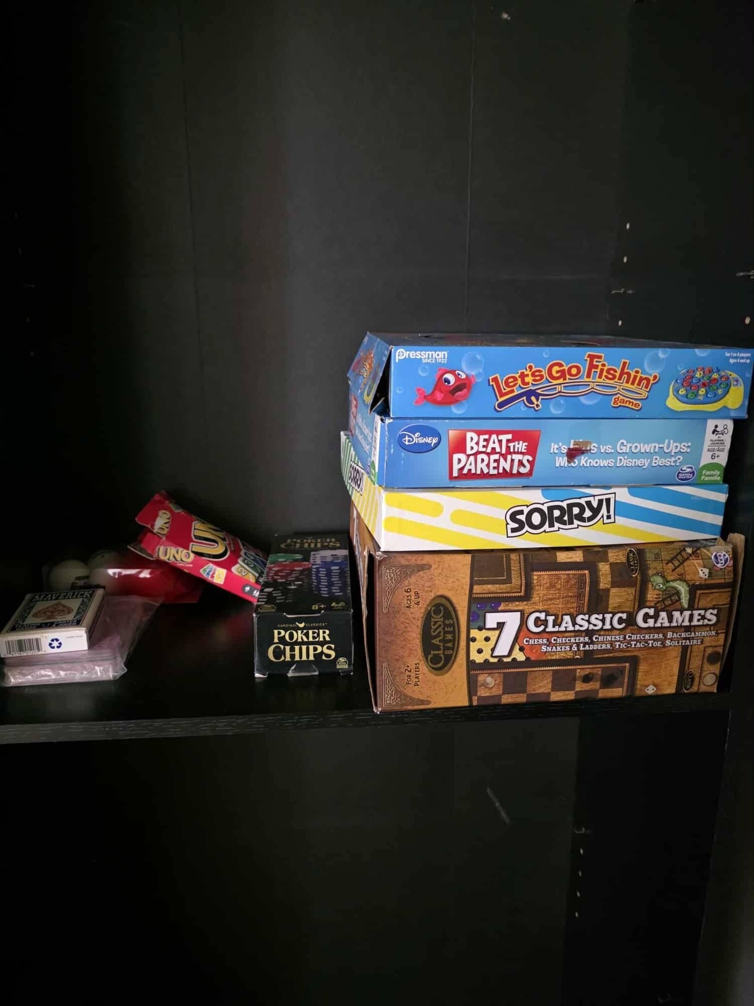 A shelf with various board games and snacks.