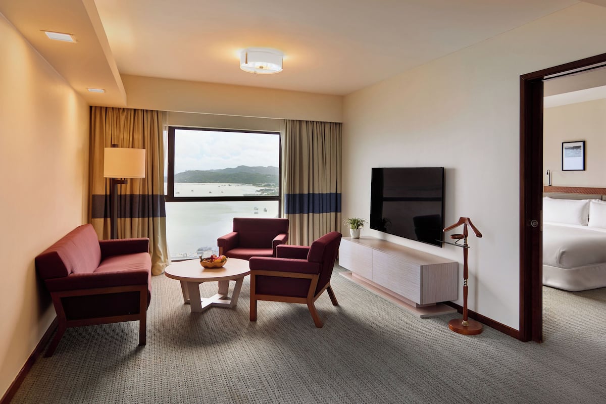 Grand Suite | Living area | 65-inch flat-screen TV with satellite channels