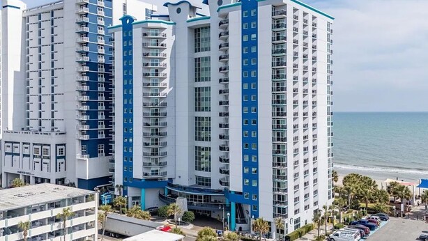 A high-rise hotel with multiple floors, balconies, and a view of the ocean. - Oceanfront Condo Gorgeous View&Pools (Myrtle Beach)