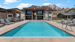 A modern hotel with a pool, lounge chairs, and a mountain backdrop. - Montclair Zion - a Stunning Luxury Villa, 2 Bed, 1 Bath Retreat with Balcony (Springdale)