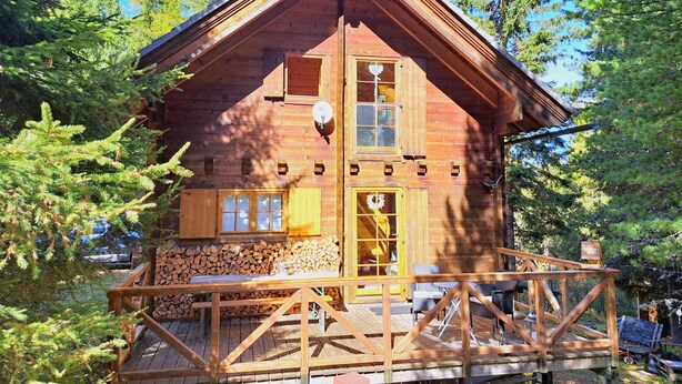A wooden cabin with a balcony, surrounded by trees. - Zirbenwaldhütt´n by Interhome (Turracher Höhe)