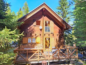 A wooden cabin with a balcony, surrounded by trees. - Zirbenwaldhütt´n by Interhome (Turracher Höhe)