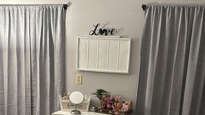 A bedroom with a bed, a dresser with drawers, a vanity with a mirror, and a wall-mounted shelf with decorative items. - Charming apartment in a great location. Near to the fun of Hartford (Hartford)
