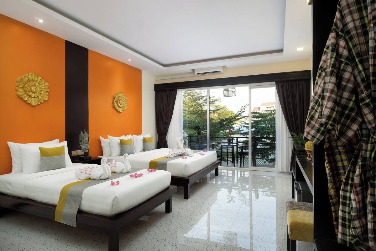 Une chambre d’hôtel avec deux lits, un balcon offrant une vue agréable et un design moderne.