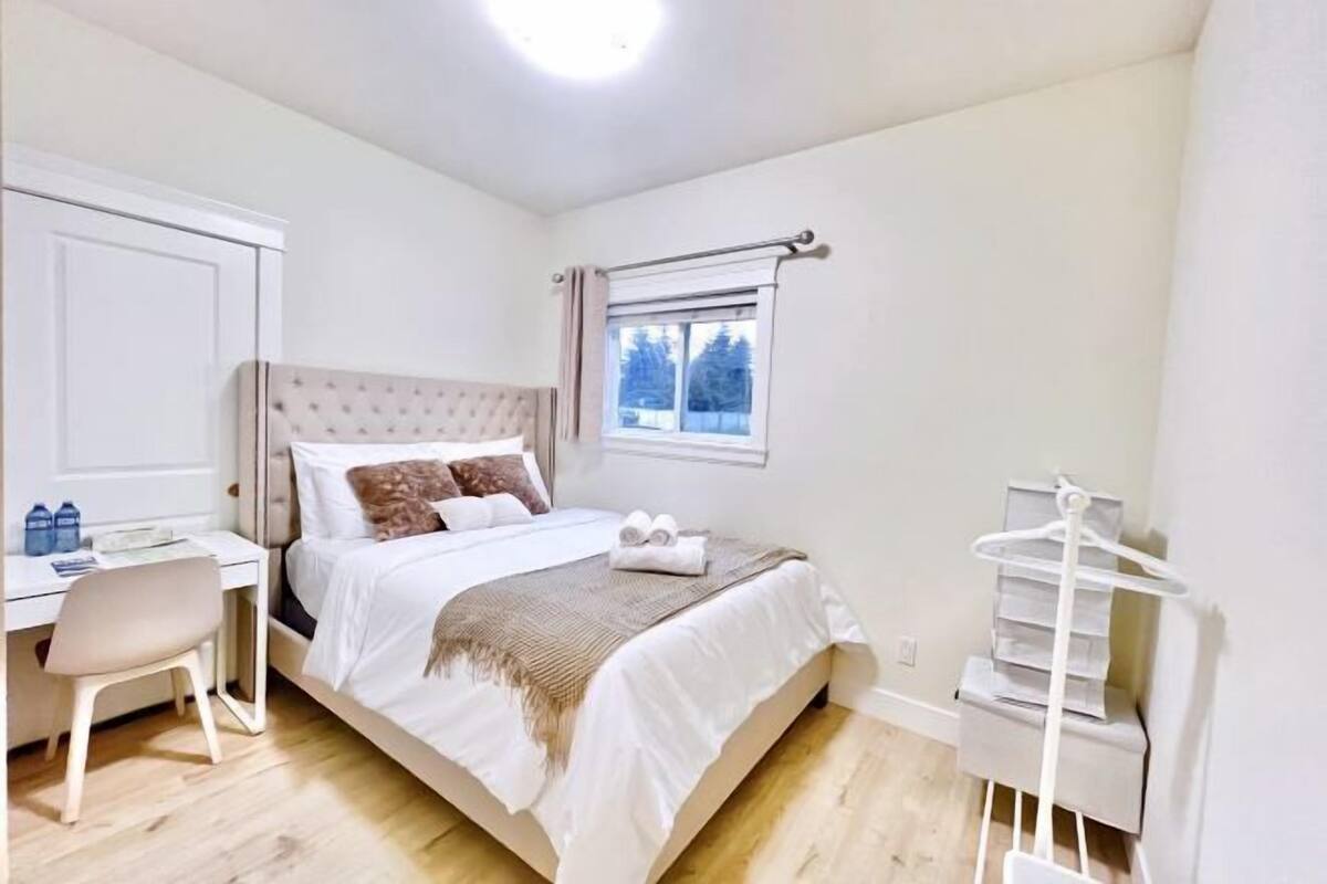Un dormitorio con cama, escritorio y silla.
