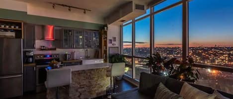 Design Apartment | Living area | 65-inch flat-screen TV with cable channels