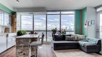 Design Apartment | Living area | 65-inch flat-screen TV with cable channels