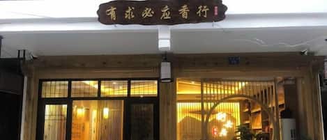 A restaurant with a traditional wooden facade and a signboard above the entrance.