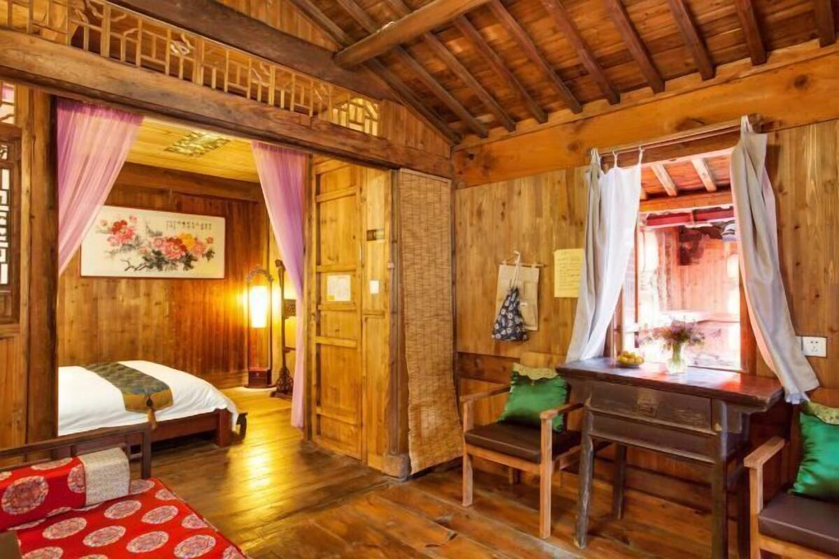 A wooden room with a bed, a desk, and a chair.