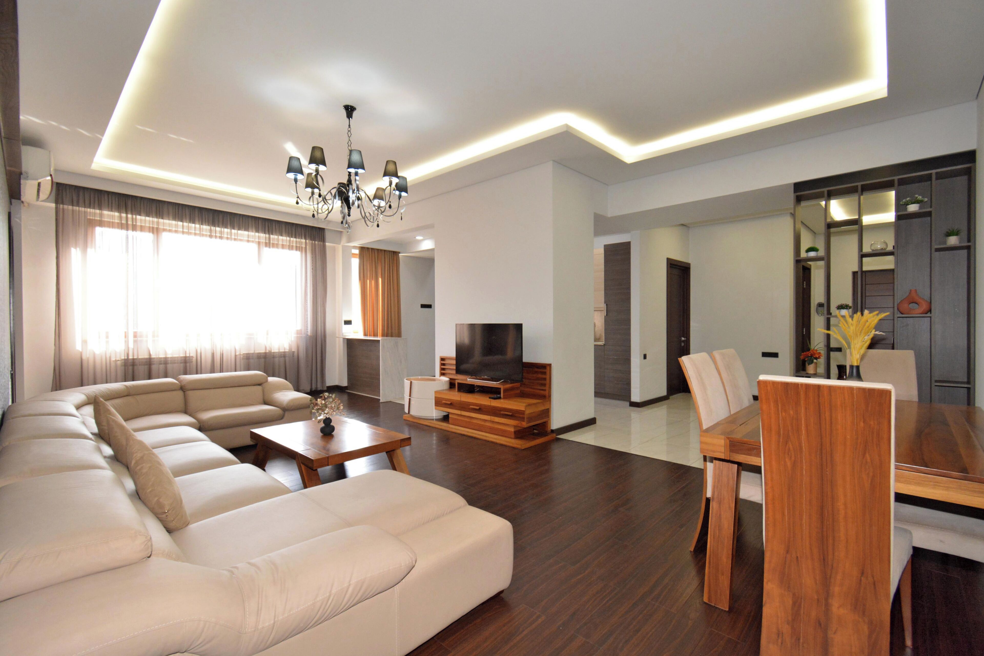 Family Apartment, Balcony, City View | Living area | 50-inch flat-screen TV with cable channels
