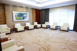 A hotel room with a large carpet, a painting on the wall, and a large window with curtains. - Northwest A&F University Foreign Expert Apartment (Xianyang)