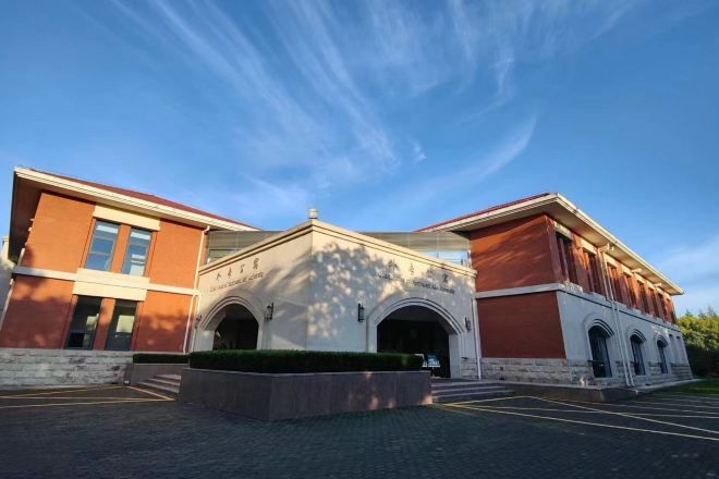 A building with a symmetrical facade, arched windows, and a central entrance.