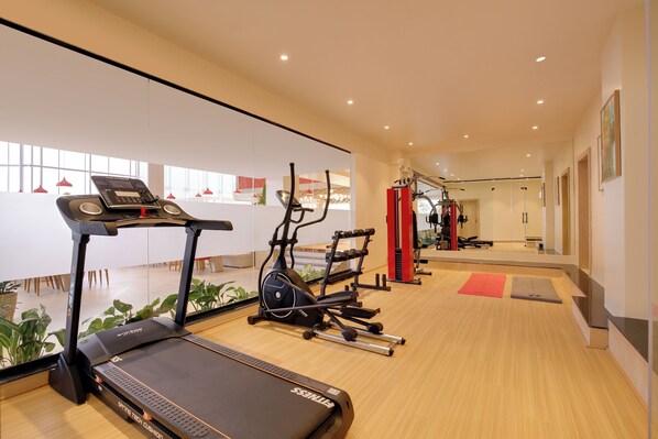 A modern gym with a treadmill, elliptical, and stationary bike. - Lemon Tree Hotel Ranchi (Ranchi)
