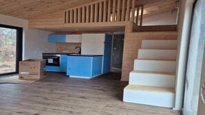 A modern interior with a kitchen area, wooden flooring, and a staircase. - 5 Star Holiday Home in Ronde (Ronde)