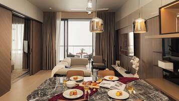 A modern dining area with a marble table, chairs, and a ceiling fan.