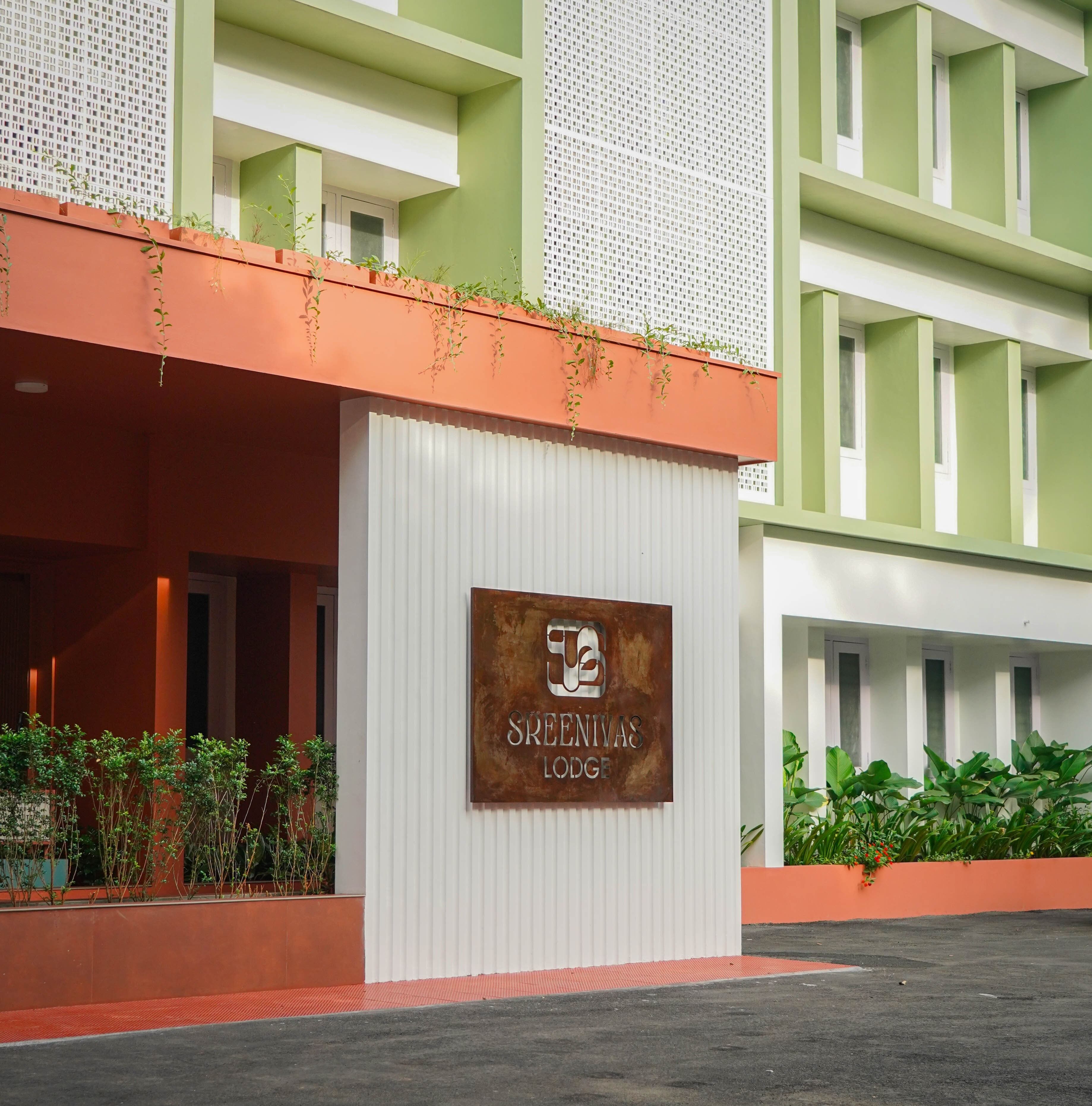A hotel entrance with a sign reading "SREENIVAS LODGE".