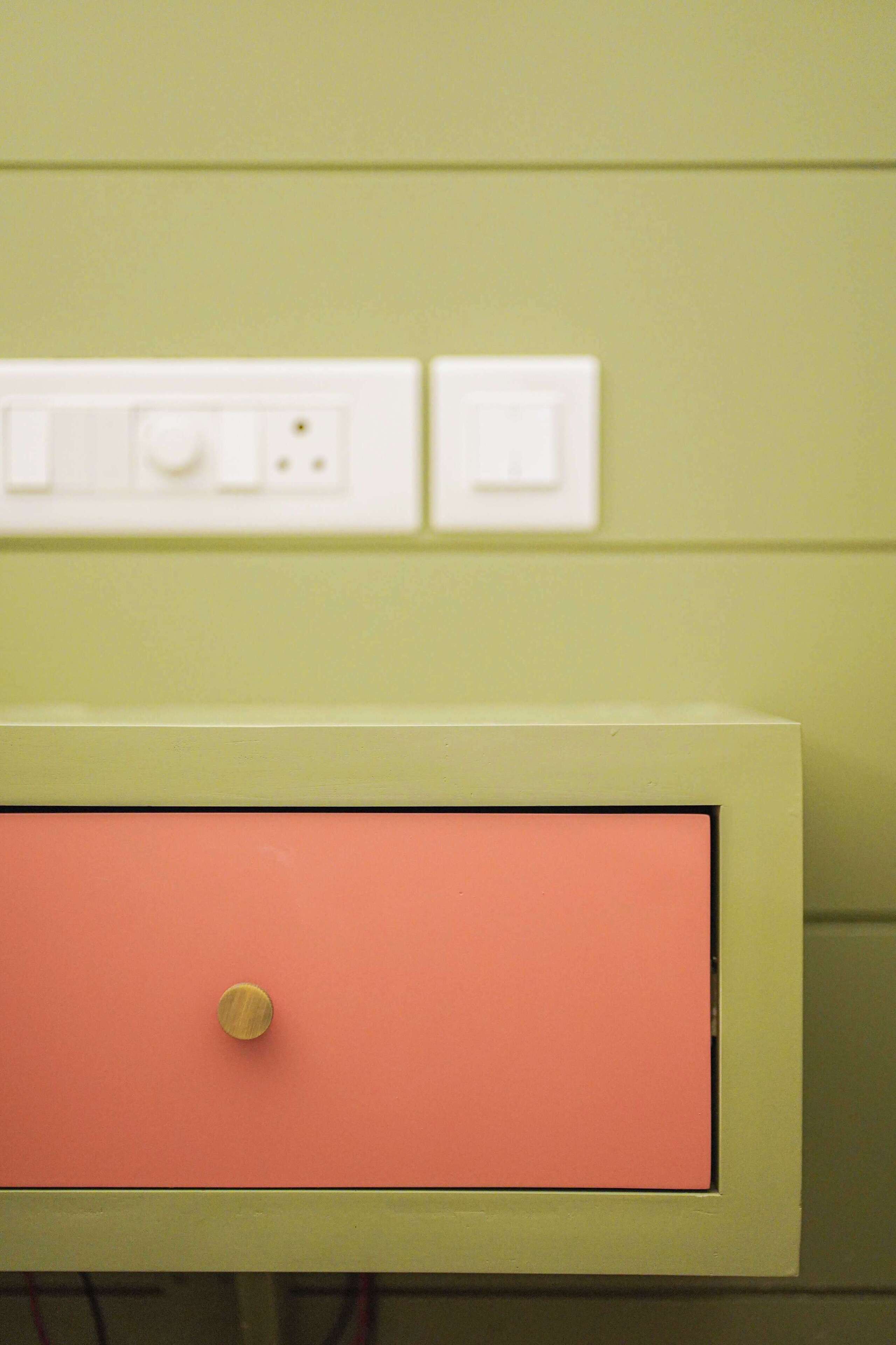 A wall with a light switch and a power outlet.