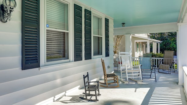 A porch with white railings, a rocking chair, and a bench. - Spacious New Bern Home w/ Yard: 2 Mi to Riverfront (New Bern)