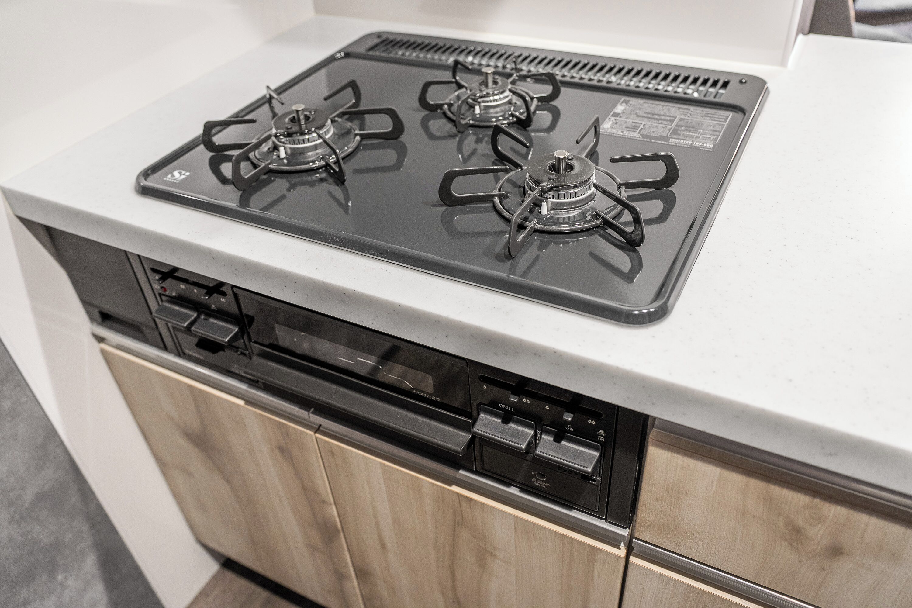A kitchen with a built-in dishwasher and a stove with four burners.
