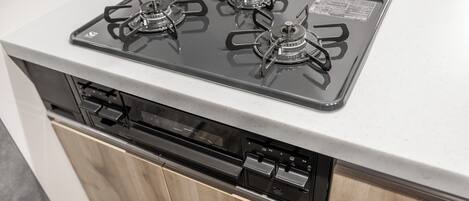 A kitchen with a built-in dishwasher and a stove with four burners.