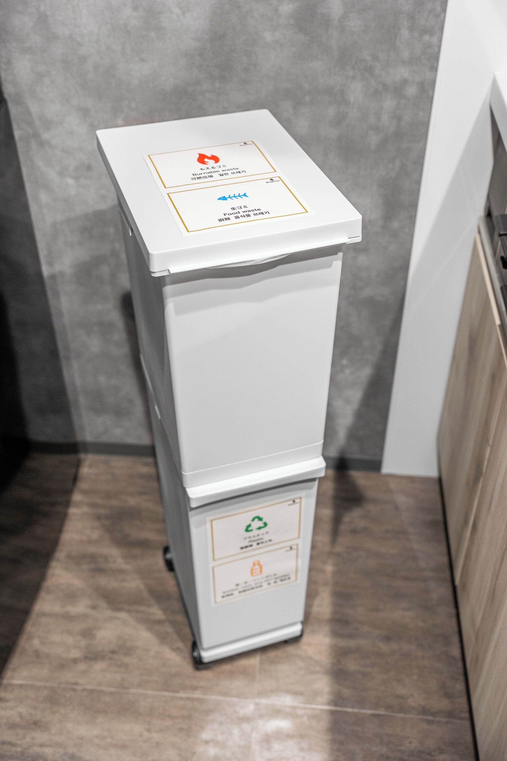 A compact, white, freestanding air purifier with a control panel and a top-mounted filter box.