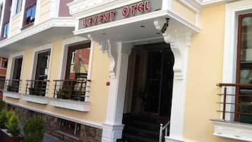 A hotel entrance with a sign reading 'LEVENT HOTEL.'