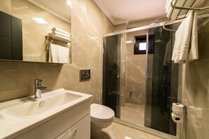 A modern bathroom with a sink, toilet, and glass-enclosed shower. - Levent Hotel Istanbul (Istanbul)