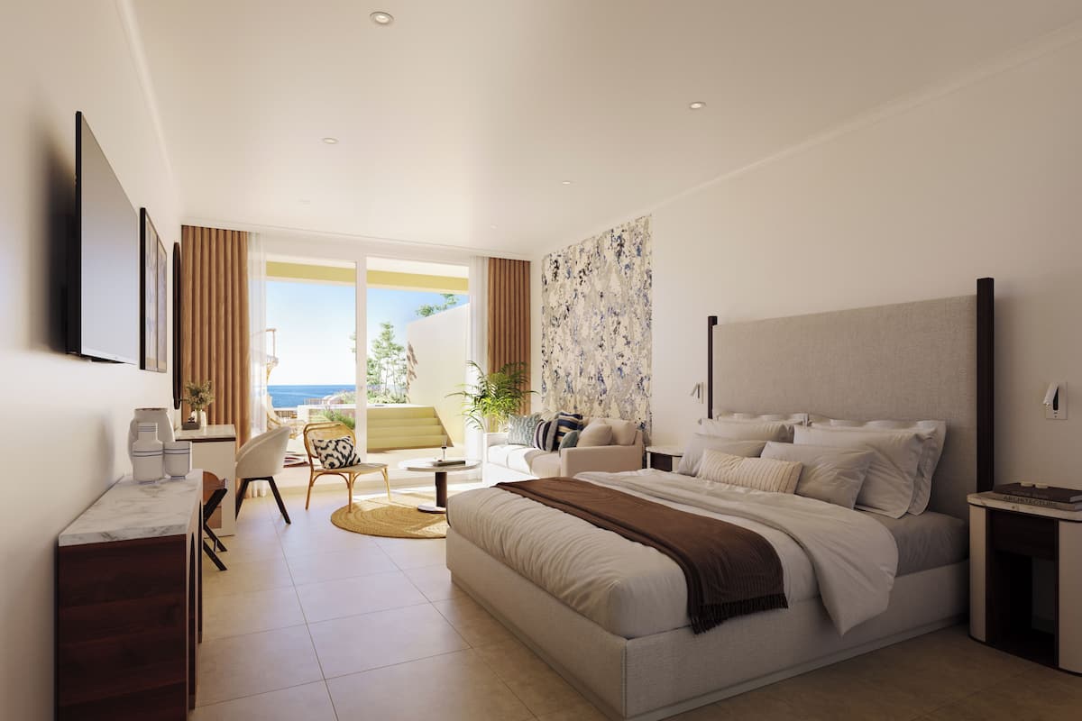 A modern hotel room with a large bed, a desk, and a balcony with a view of the sea.