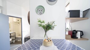 A reception area with a reception desk, a vase with flowers, a microwave on a shelf, and a framed animal head on the wall.