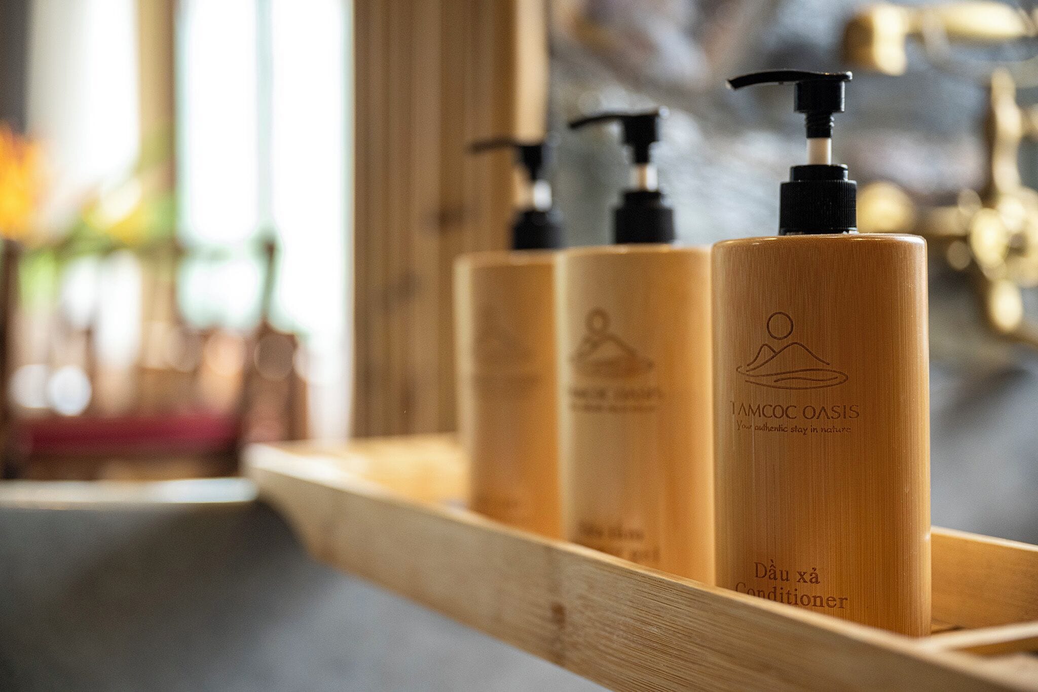 A wooden shelf with three bottles of body care products.