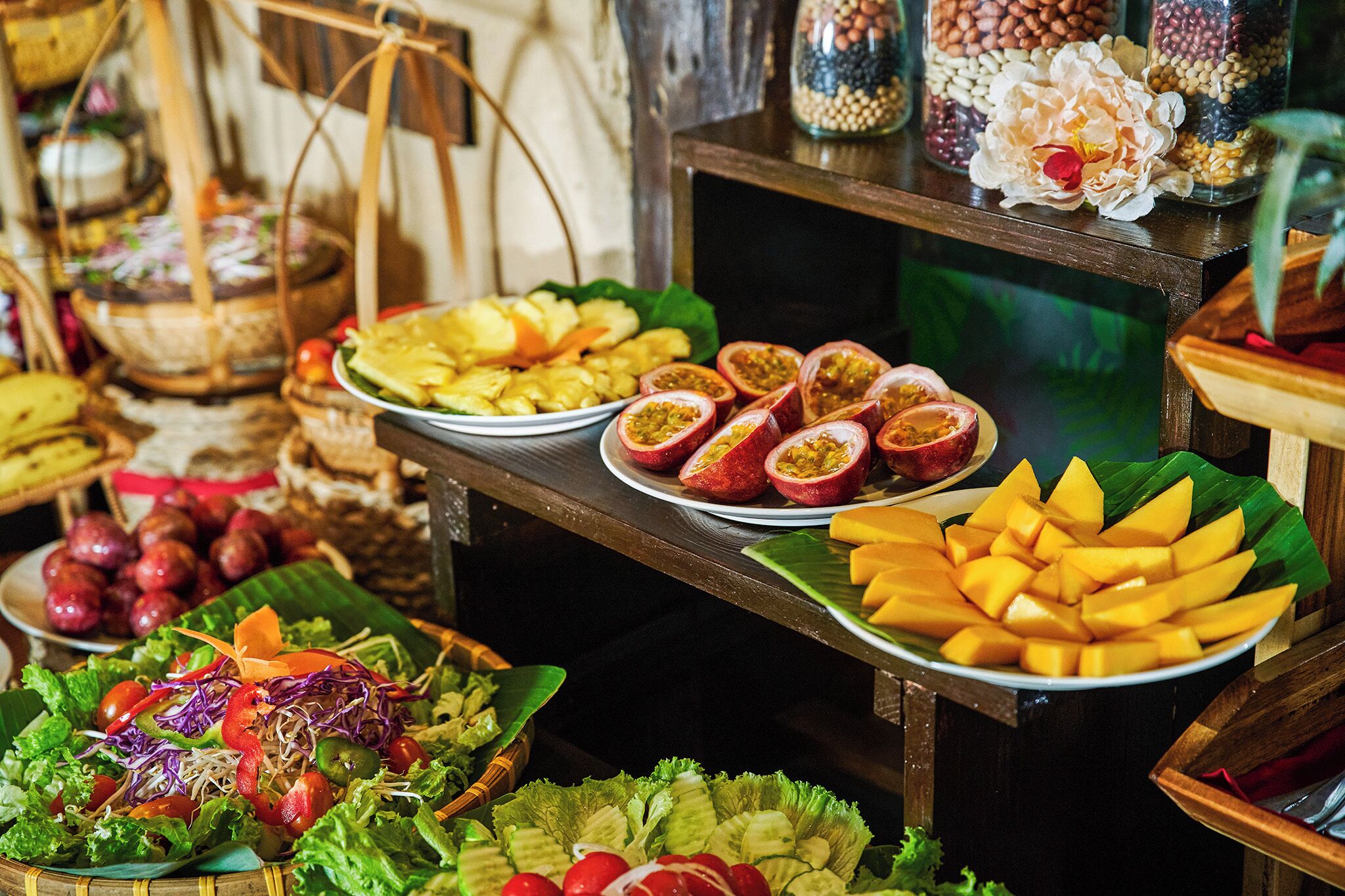 A buffet with various fruits, vegetables, and salads.