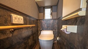 A modern bathroom with a toilet, a hand dryer, and a wall-mounted control panel. - Closest whole house from Haneda Airport (Higashikojiya, Ota-ku)