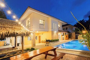 A two-story house with a swimming pool, a covered patio, and a wooden bench. - Poolnest Villa Private Saltwater Pool Retreat (Krabi)
